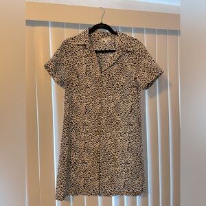 Leopard print. Button up short sleeve dress with adjustable cinched waist